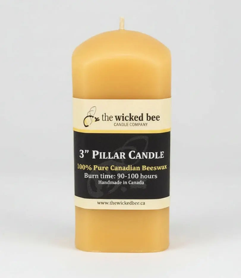 pure beeswax pillar candle with a label on a white background 3x4 square