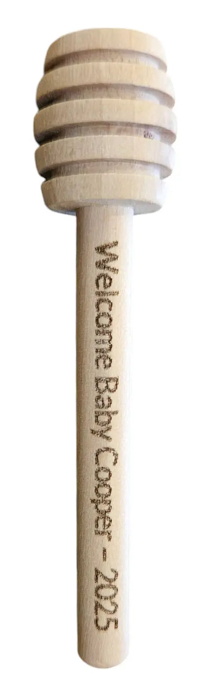Wooden honey dipper with engraved text on a white background - honey bee naturals