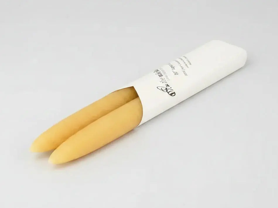 Two taper candles in a white paper cone on a white background - Honey Bee Naturals