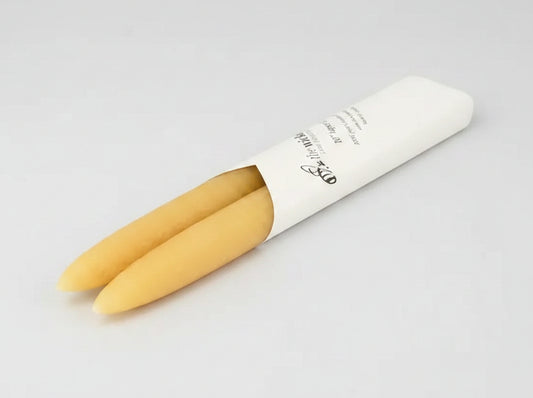 Two taper candles in a white paper cone on a white background - Honey Bee Naturals