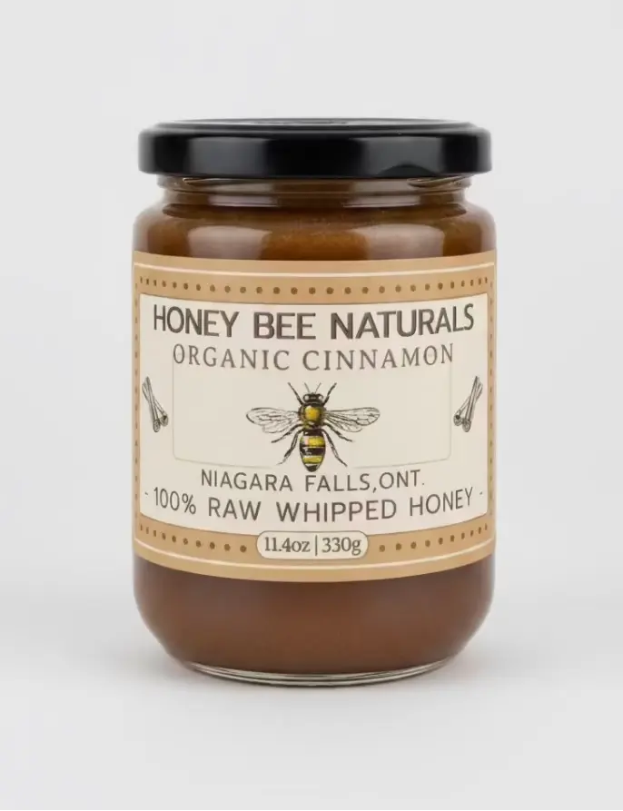 Jar of Honey Bee Naturals organic cinnamon honey on a wooden surface with a blurred background
