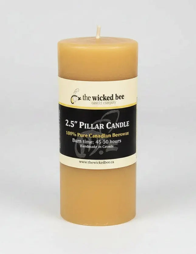 Beeswax pillar candle with a label on a white background - Honey Bee Naturals