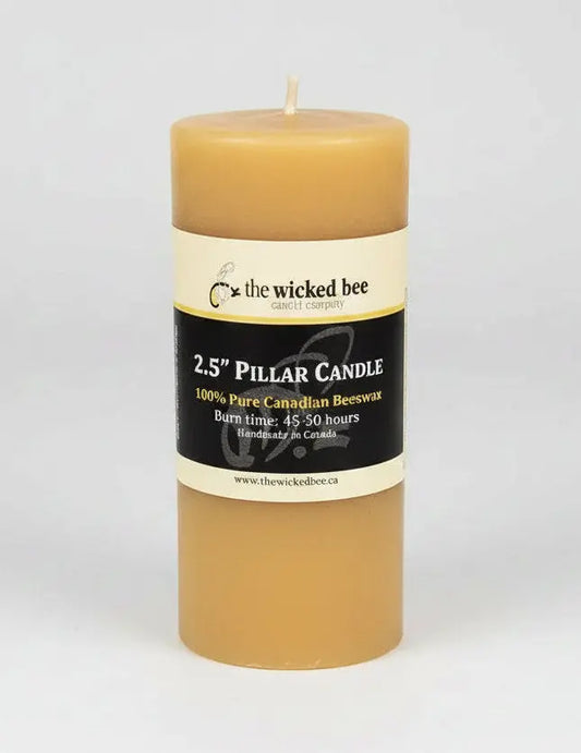Beeswax pillar candle with a label on a white background - Honey Bee Naturals