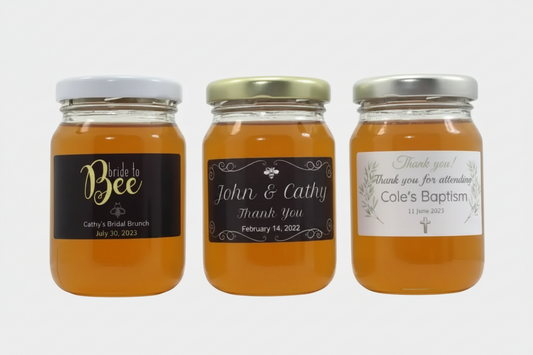 Three jars of honey with personalized labels on a white background